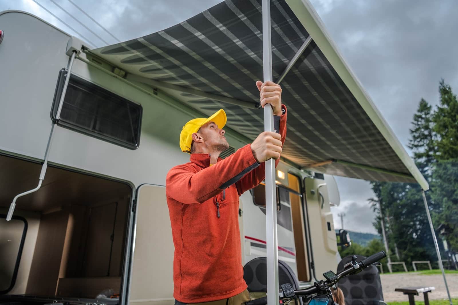 An extended patio awning shading the side of an RV.