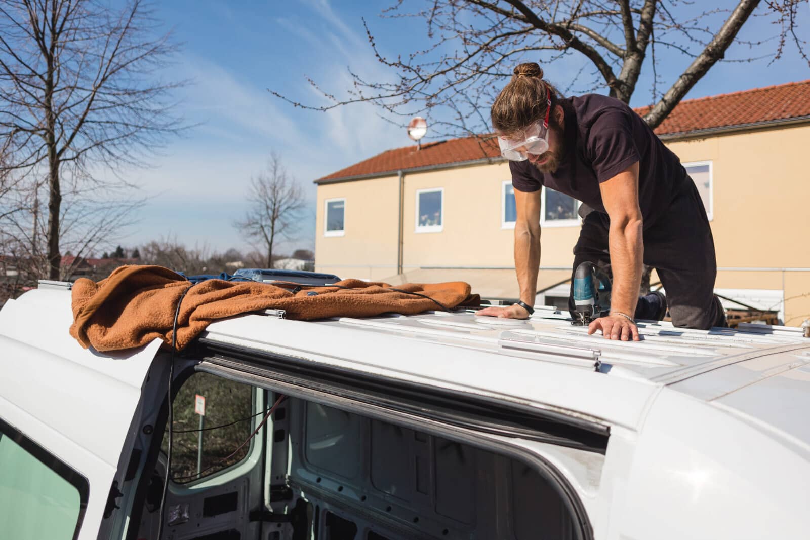 The rubber membrane roof of an RV with sealed seams and roof vents.